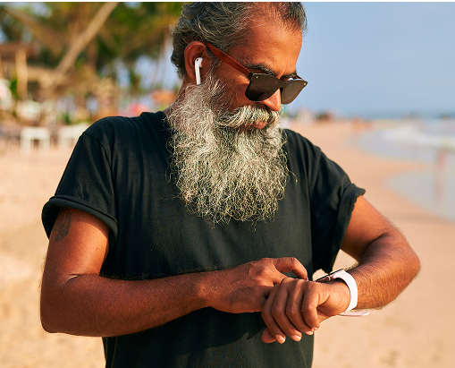 An older man checks his smart watch