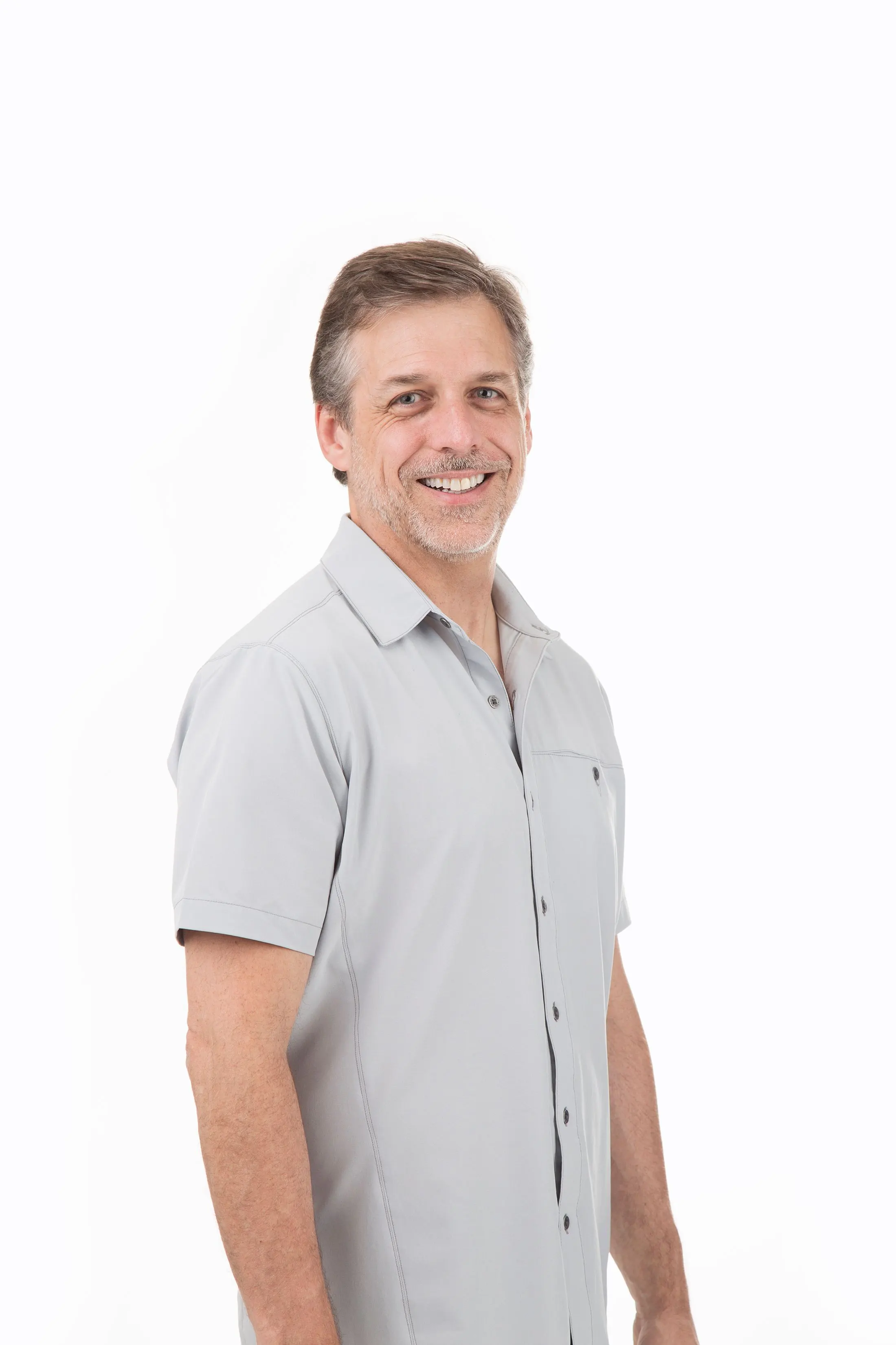 Man standing with his hands by his side.