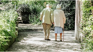 A very eldery couple walking together