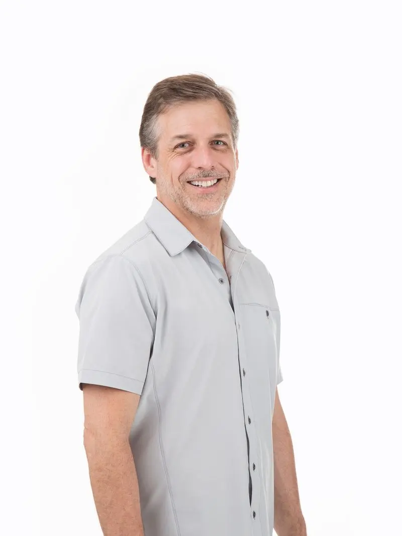 Man standing with his hands by his side.