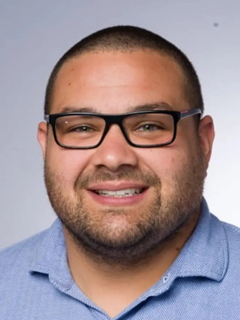 Man with glasses smiling