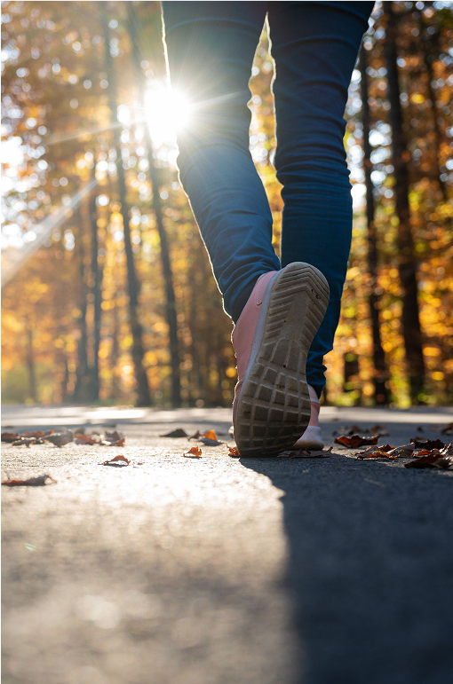 A photo taken low to the ground of a person walking away from the camera